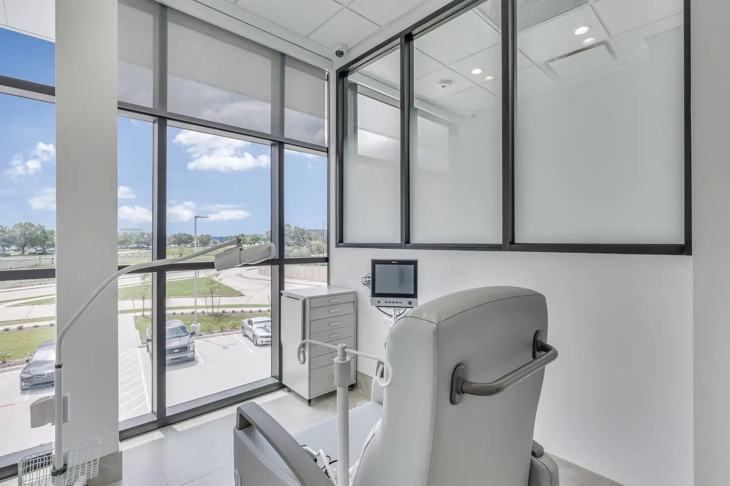 An infusion bay with patient monitoring equipment beside the treatment chair