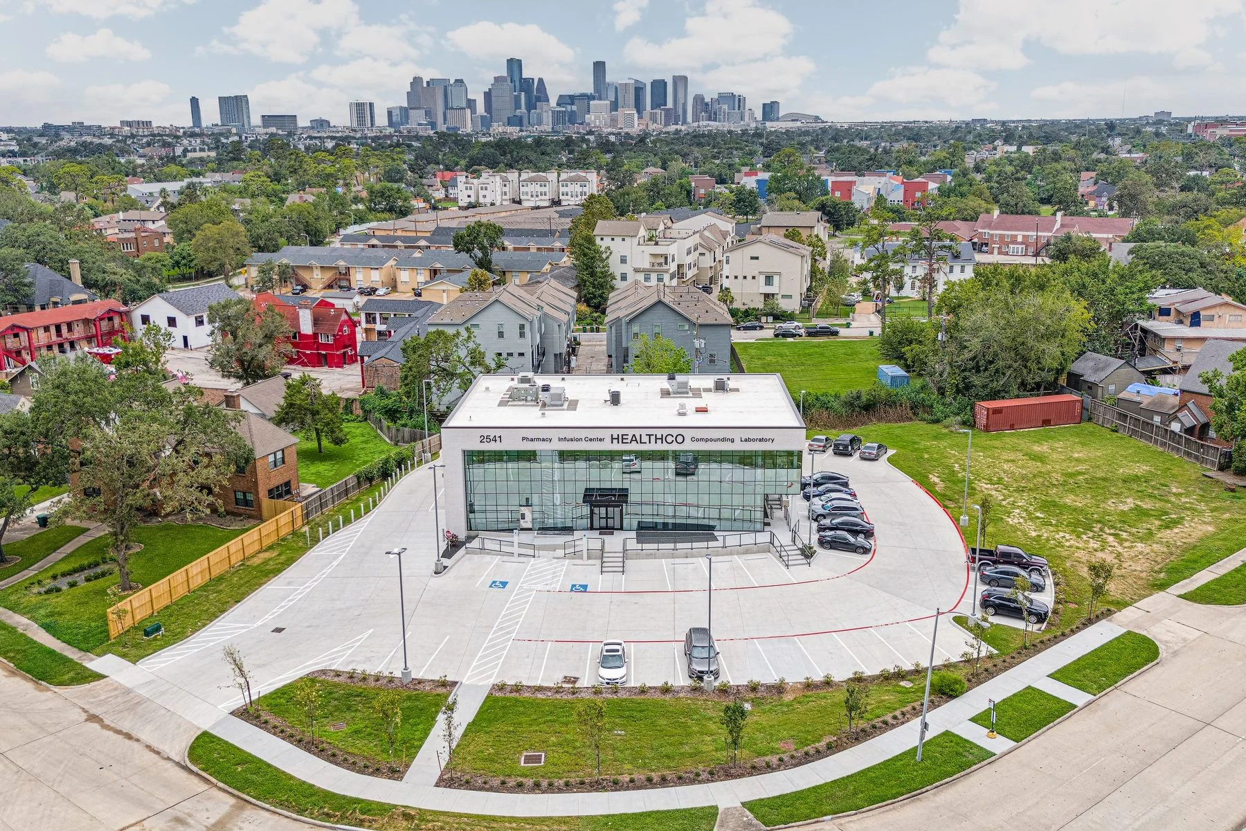 Aerial view of the HealthCo building with the Houston skyline on the horizon