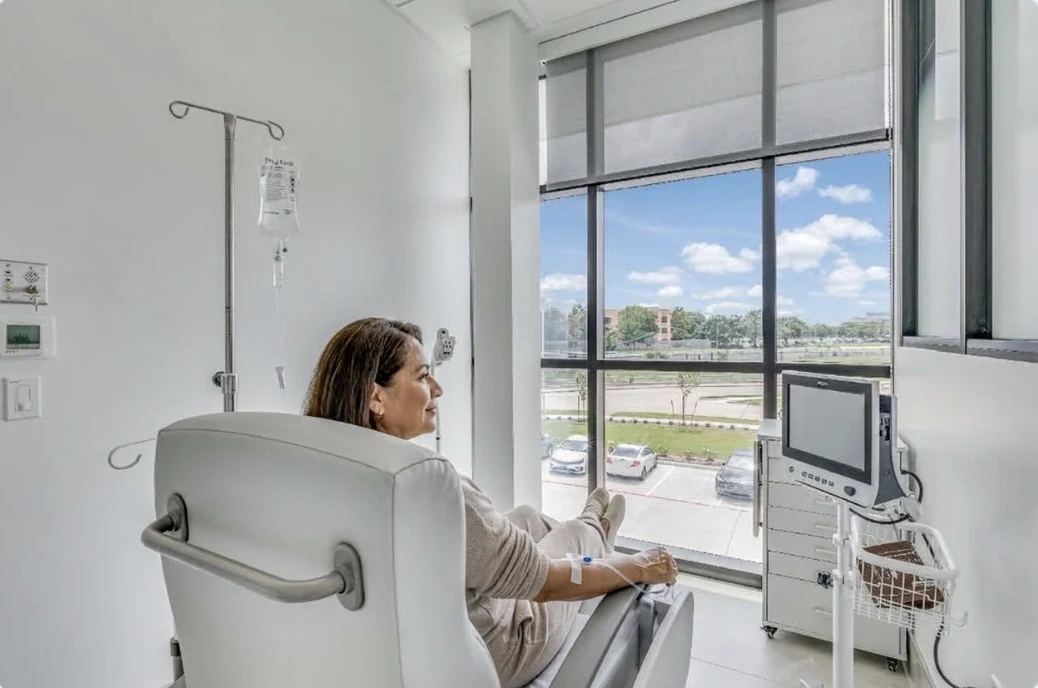A patient relaxing in an infusion chair by the window