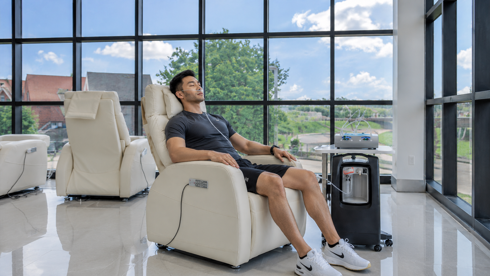 A patient relaxing in a comfortable reclining chair during infusion therapy in HealthCo's sunlit suite