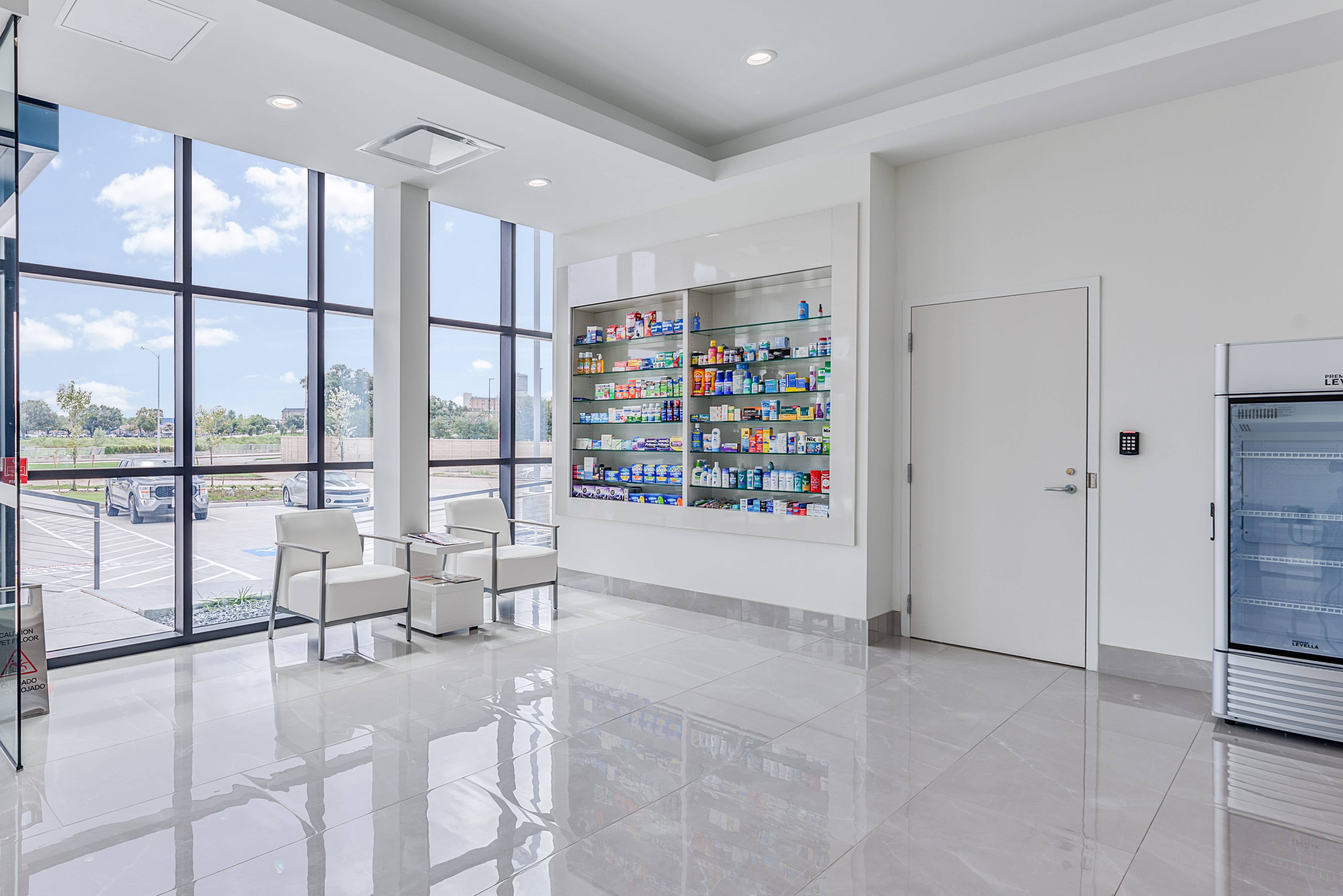 The bright, modern retail floor inside HealthCo with wellness shelves and a comfortable waiting area